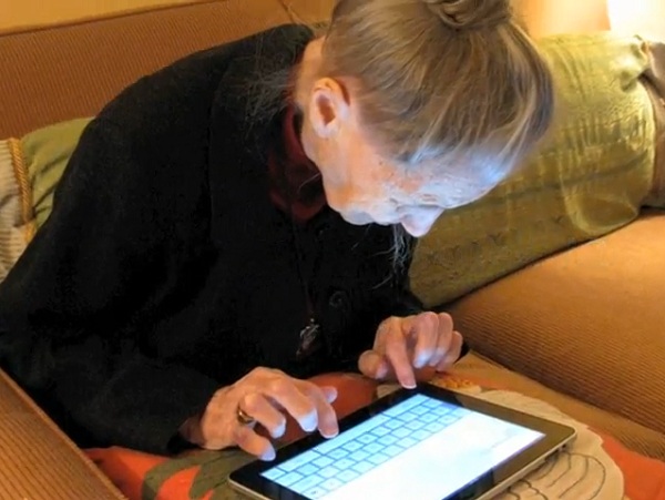 A 100 year old Virginia woman types on her iPad
