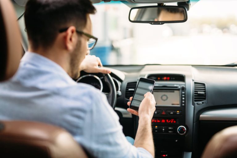 Should reading while driving be banned like tech devices?