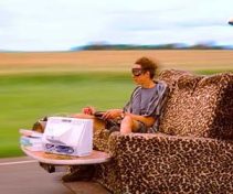 A surreal double-decker drivable couch