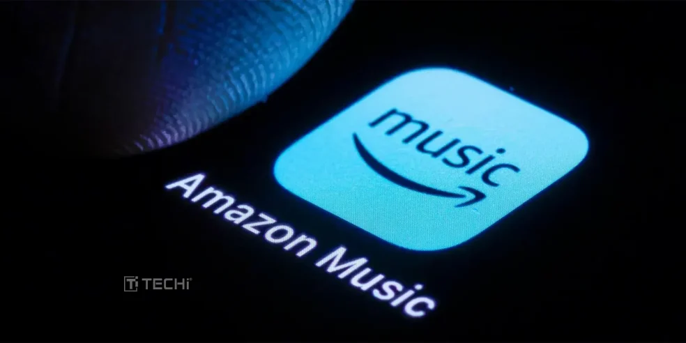 Amazon Music app icon glowing on a smartphone screen with a finger hovering above.