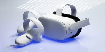 Oculus virtual reality headset and controllers placed on a reflective surface with soft lighting.