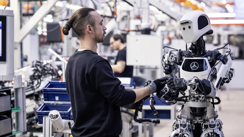Mercedes Apollo humanoid robot working alongside a factory employee in an advanced manufacturing facility