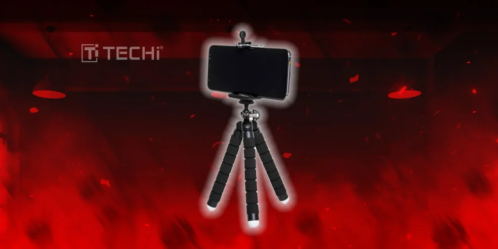 Flexible smartphone tripod with mounted phone against a red glowing background.