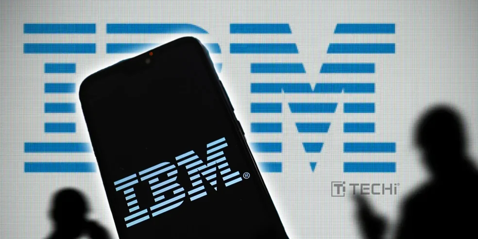 Silhouette of a smartphone displaying the IBM logo in front of a large IBM logo projection with shadows of people around