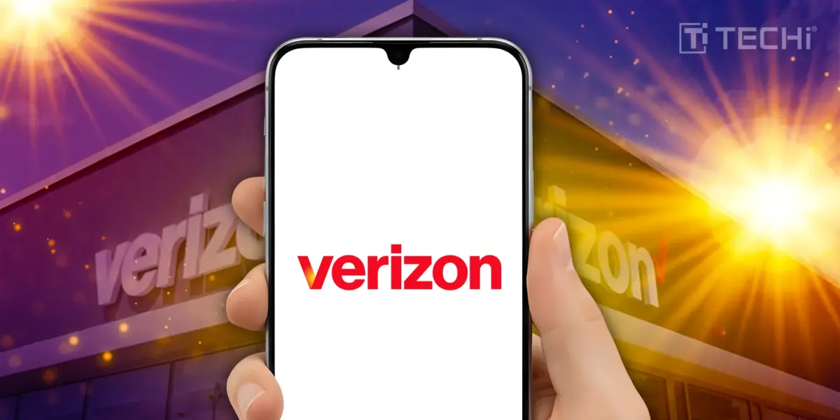 Person holding smartphone with Verizon logo in front of a Verizon store under a purple sky.