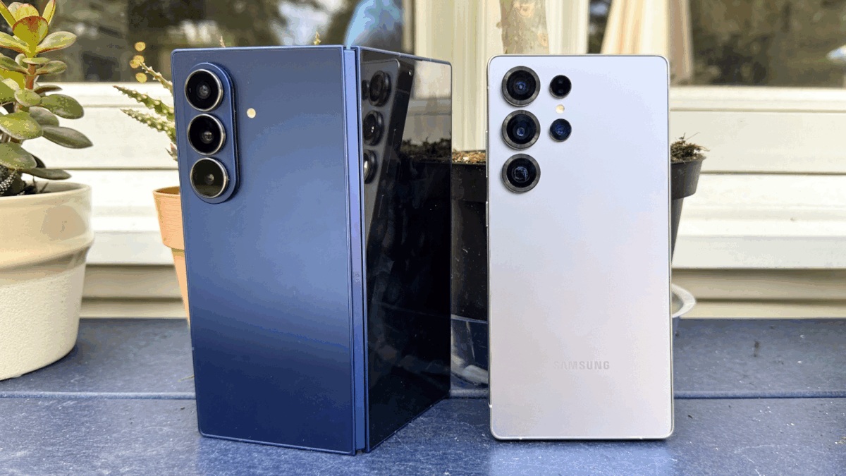 Side-by-side comparison of two Samsung smartphones: a Galaxy Z Fold (blue) and a Galaxy S Ultra (white). Both devices display their rear camera setups with multiple lenses visible, showcasing their premium design.