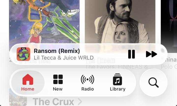 iOS 26.1 reinvented Transparency Control and User Experience at Apple 2 Screenshot of a music streaming app interface, showing "Ransom (Remix)" by Lil Tecca & Juice WRLD playing at the bottom. The player bar includes play/pause and skip controls. Above it are album covers or promotional images, and the bottom navigation bar displays icons for Home, New, Radio, and Library.