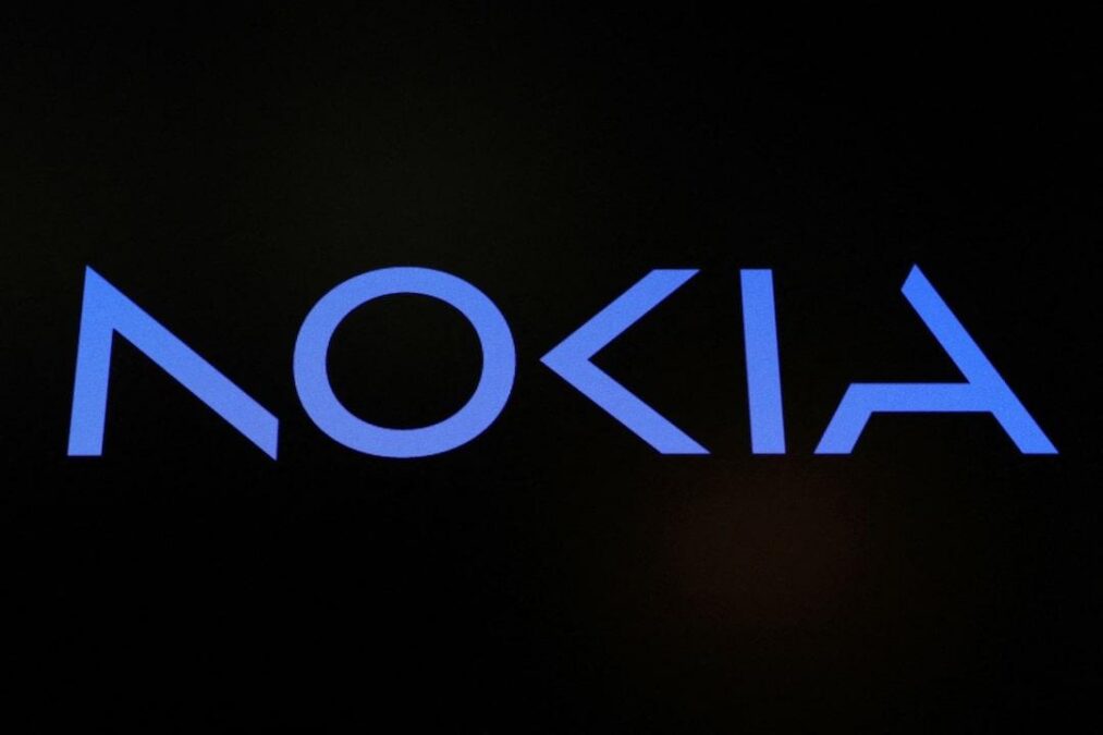 A screen displays the company logo for Nokia Corporation on the floor of the NYSE in New York